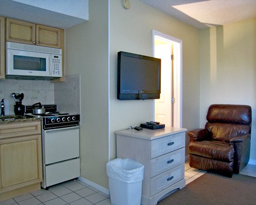Living room with an open plan kitchen and television.