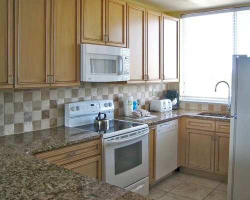 A well equipped kitchen with breakfast bar.