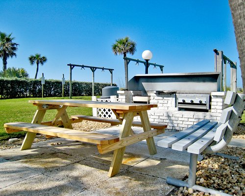 An outdoor picnic area and barbecue grill.