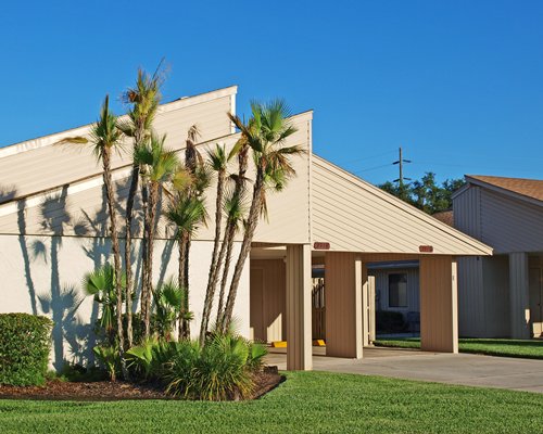 An exterior view of a resort units alongside a manicured lawn.