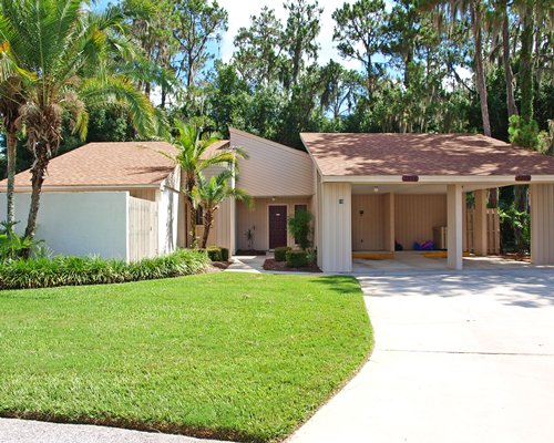 An exterior view of a resort units alongside a manicured lawn.