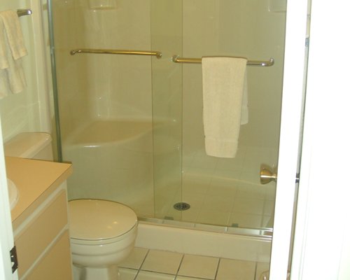 A bathroom with a single sink vanity and a stand up shower.