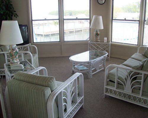 A well furnished living room with a telephone and an outside view.