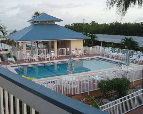 An outdoor swimming pool with chaise lounge chairs.