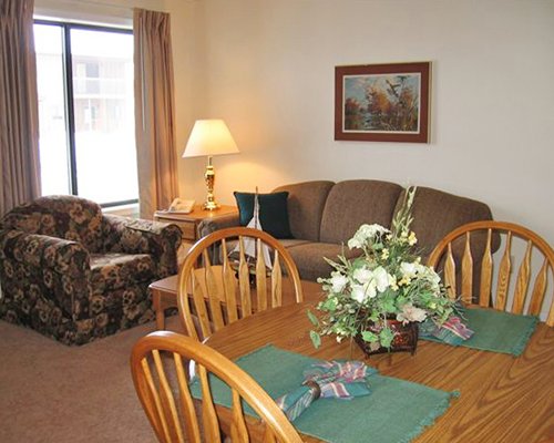 An open plan living and dining area with a pull out sofa.