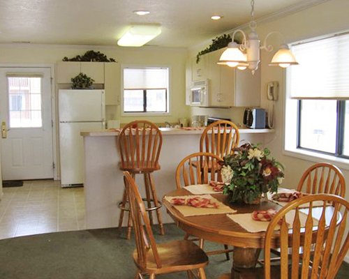An open plan kitchen with a dining area breakfast bar and outside view.