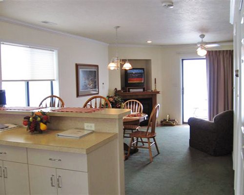 An open plan living room with a television fireplace and dining area.