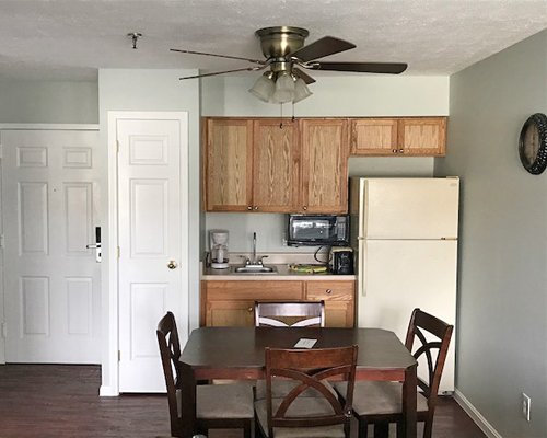 An open plan dining and kitchen area with a refrigerator.