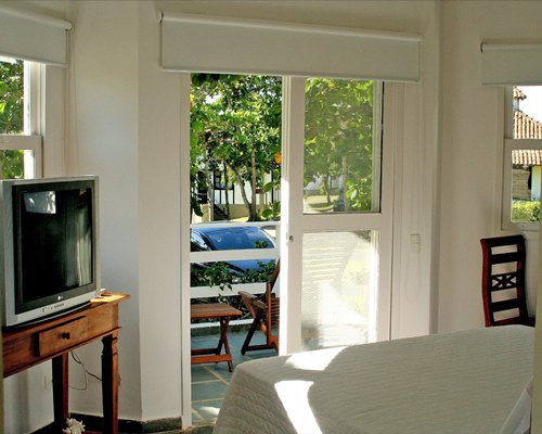 Furnished living room with a television patio and patio furniture.