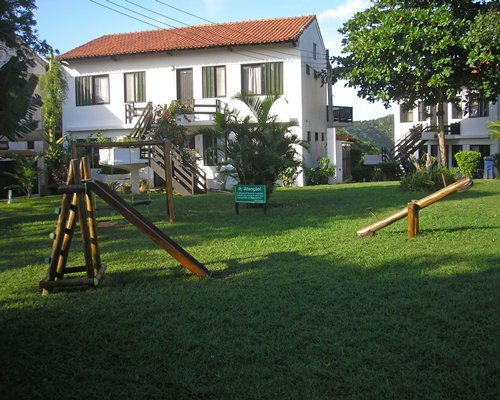 An outdoor playscape alongside resort units.