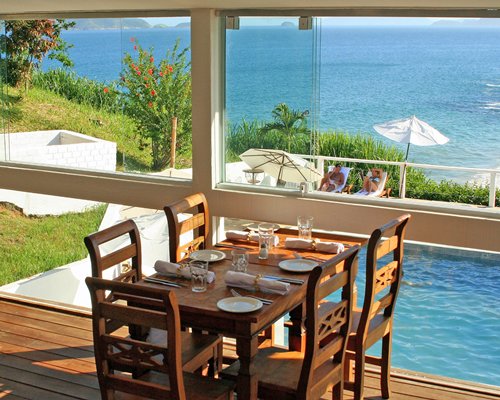 A well furnished dining area with a beach view.