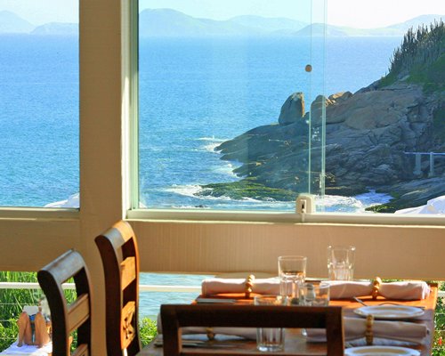 A well furnished indoor fine dining restaurant with an ocean view.