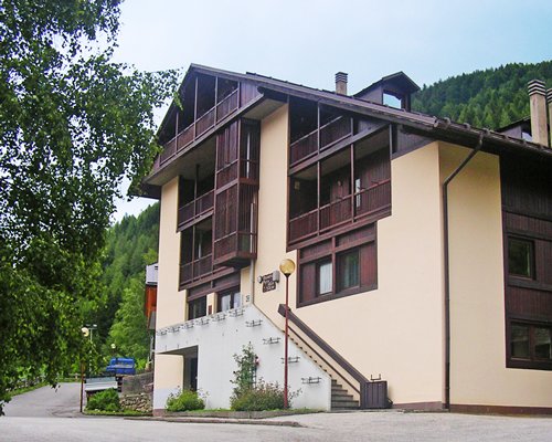 Exterior view of Domina Home Parco Dello Stelvio resort covered in snow.