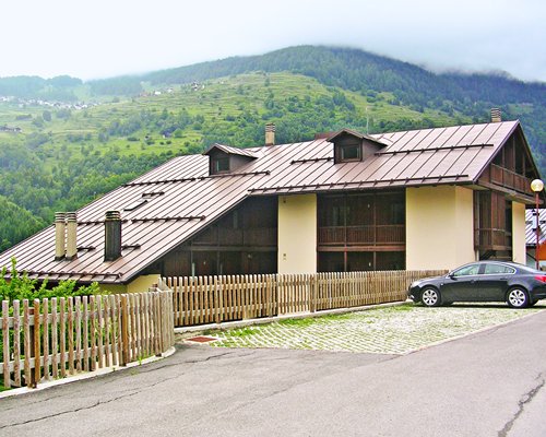 Exterior view of a unit with parking lot surrounded by mountains.