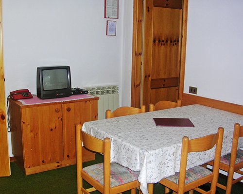A well furnished bedroom with queen bed and balcony.