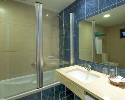 A bathroom with single sink vanity.