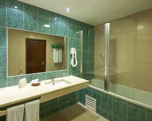 A bathroom with single sink vanity.