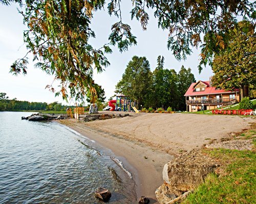 A view of multi story resort units alongside the lake.