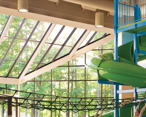 Indoor theme park with slides and outside view.