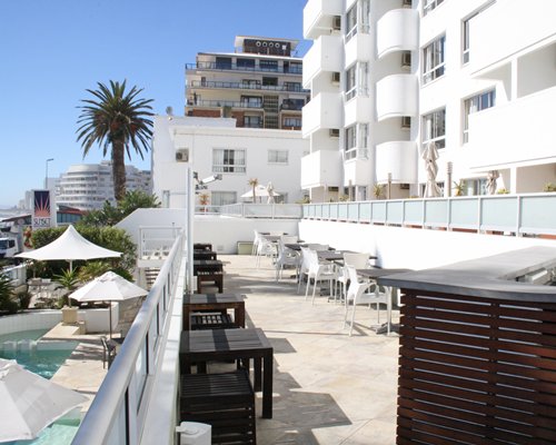 An outdoor restaurant alongside multi story units.