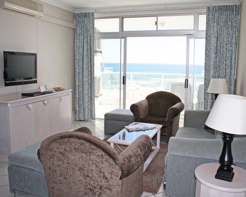 A well furnished living room with a television and outside view.
