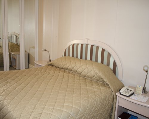 A well furnished bedroom with a telephone.