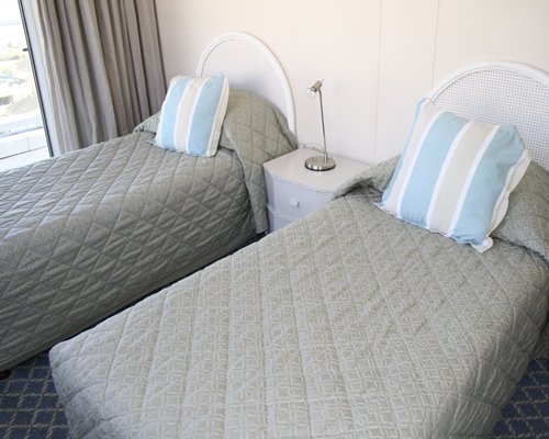 Bedroom with two twin beds and outside view.