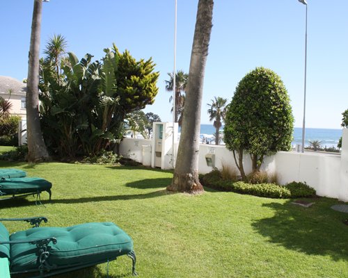 Outdoor picnic area with chaise lounge chairs and ocean view.