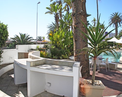 Scenic picnic area alongside swimming pool.