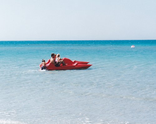 A couple kayaking on a beach.