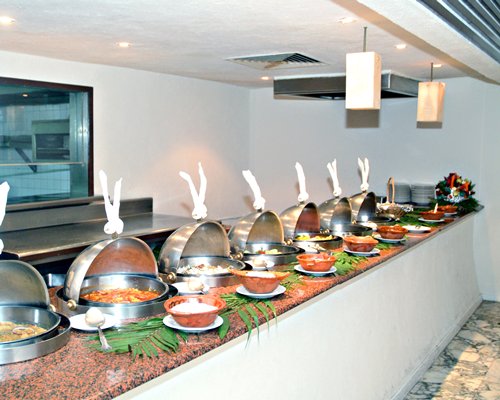 An indoor buffet area with various dishes.