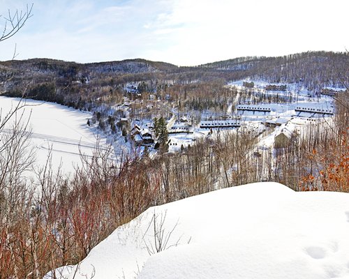 An exterior view of the resort properties covered in snow with pine trees.