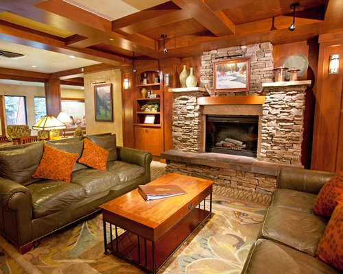 A well furnished living room with double pull out sofa and a fireplace.
