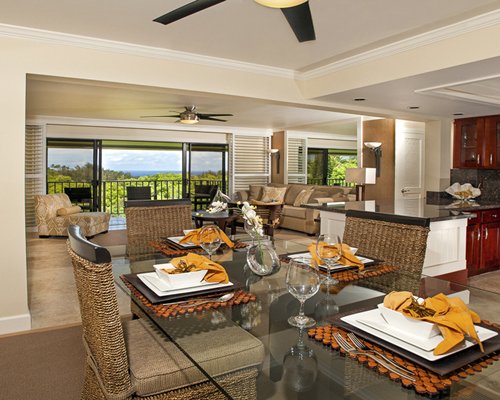 A well furnished indoor common room alongside a dining table.