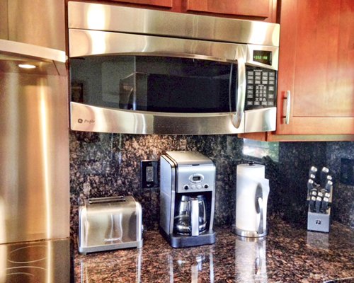 A view of kitchen accessories alongside a microwave oven.