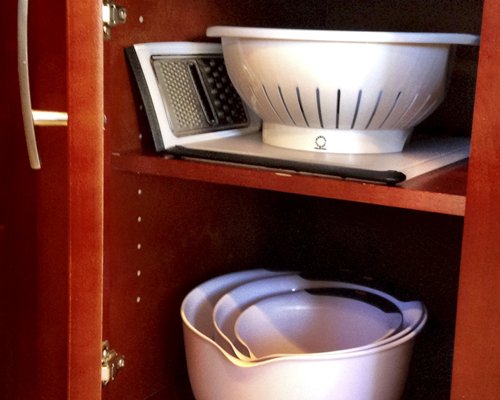 View of the kitchen accessories in a cupboard.