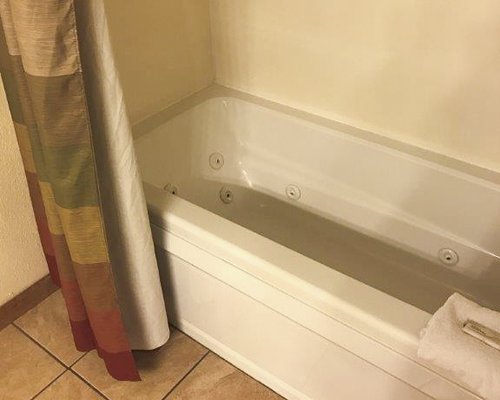 A bathroom with a bathtub and a shower.