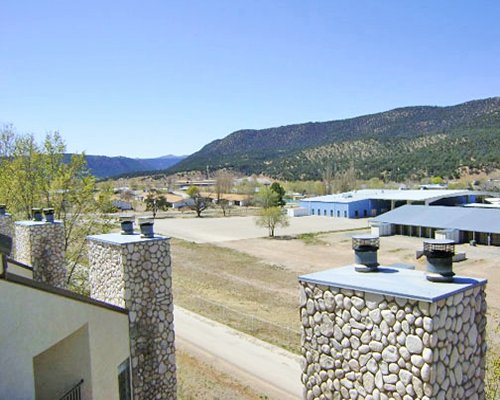 An exterior view of resort units at a foothill.