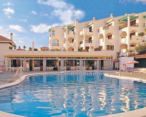 A large outdoor swimming pool alongside the resort units.