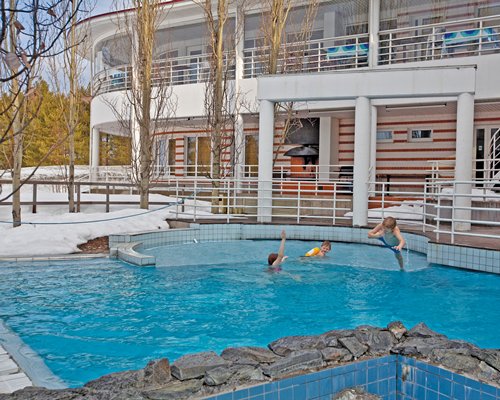 An outdoor swimming pool alongside resort units.
