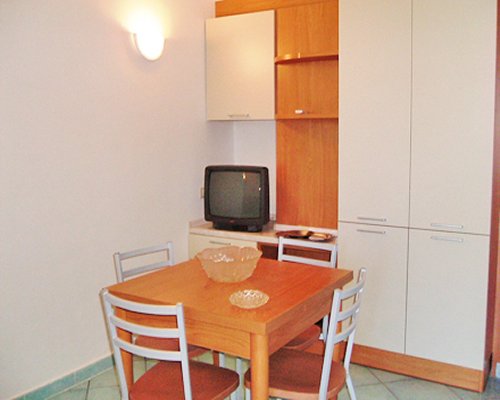 A well furnished dining room with a television.