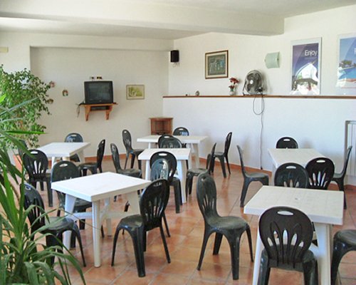 A well furnished restaurant area with a television.