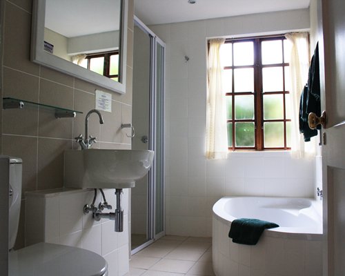 A bathroom with a single sink vanity and a bathtub.