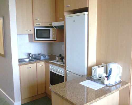 A well equipped kitchen with breakfast bar.