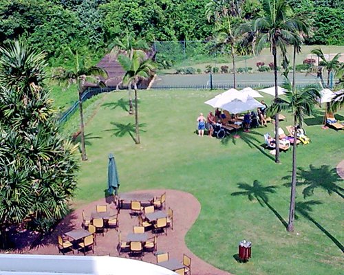 Balcony view of the resort alongside the chaise lounge chairs and patio furniture.