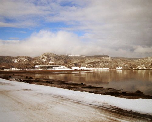 View of the beach alongside mountains during winter.