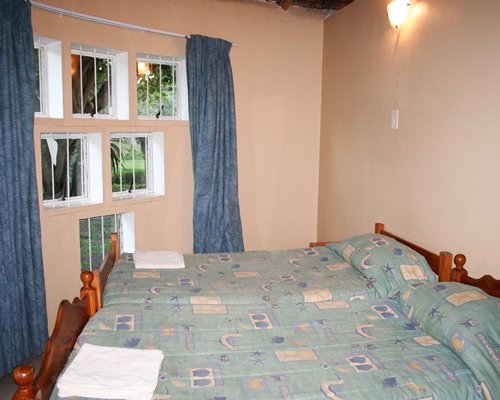 A well furnished bedroom with double bed and an outside view.