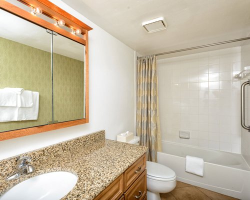A bathroom with a bathtub and sink vanity.