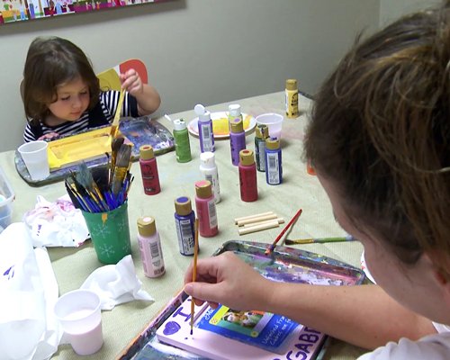 View of two kids painting.