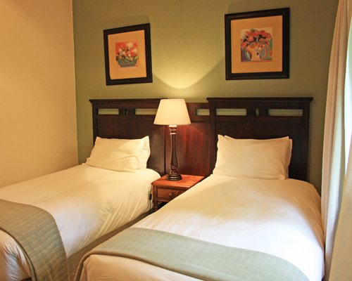 A well furnished bedroom with two twin beds.